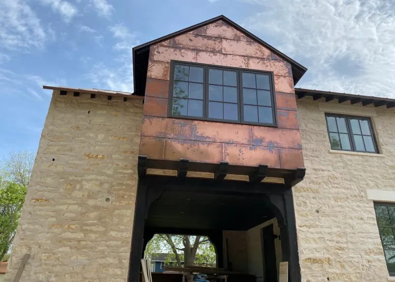 Copper metal panel facade on a stone building for Roof Repair in Hebron