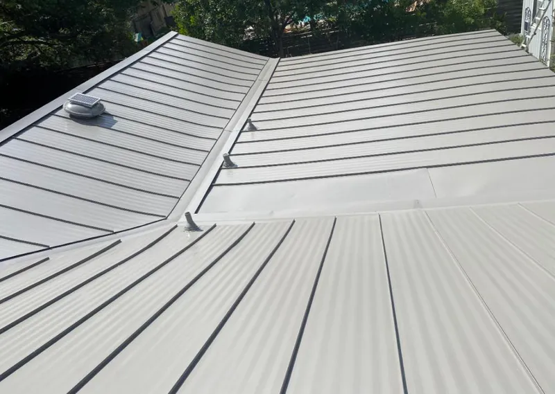 Solar attic fan installed on a metal roof for Roof Ventilation in Hebron